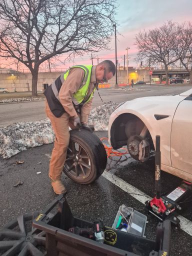 Roadside assistance in jersey city NJ fixing flat tire and helping driver