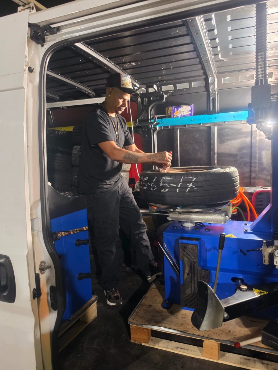 Happy Road Services working on the service van Happy Road Services Tech Replacing valve stem on a tire