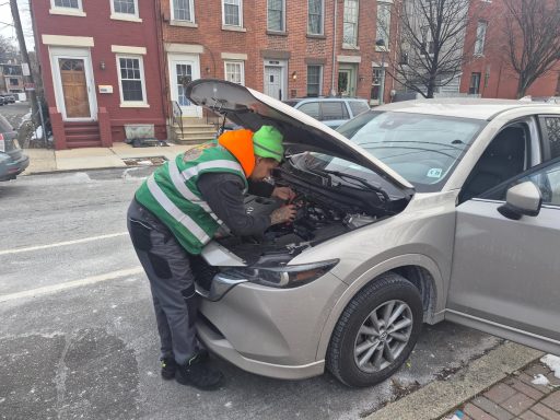 Roadside assistance in Hoboken NJ Doing a Battery Jumpstart and helping driver