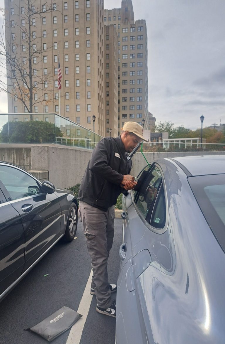 Happy road services tech doing a car unlocking in Jersey City NJ 