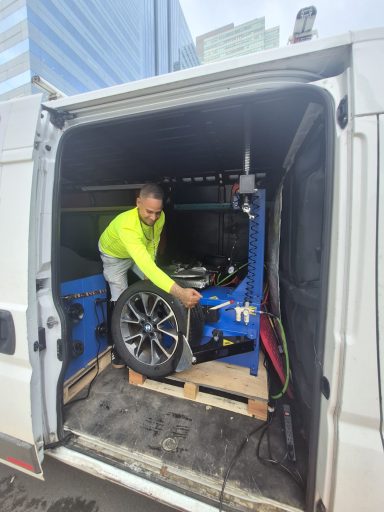 Tire replacement service in North Bergen NJ — Happy Road Services replacing a damaged tire on an SUV