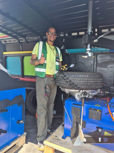 Mobile tire repair in Hoboken NJ — technician patching a punctured tire on the street