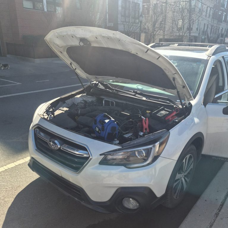 Roadside assistance doing a jump start on a car battery in Hoboken NJ 